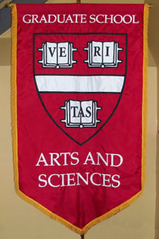An appliqued gonfalon for Harvard University graduate school of Arts and Sciences graduation ceremony.