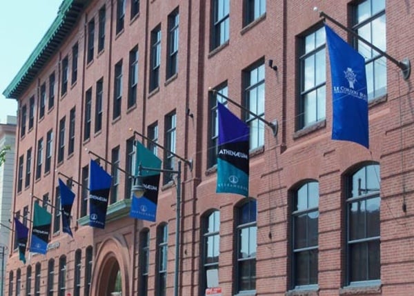 A colorful series of right trapezoid flags flying in Cambridge, MA.