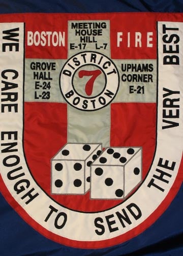 Close up of an appliqued flag for display in a museum celebrating Boston Fire Fighters.