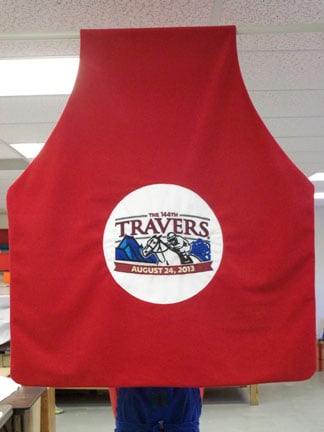 This fleece blanket has an appliqued logo and is made to drape over the winning horse of the Travers Race in Saratoga Springs, NY.
