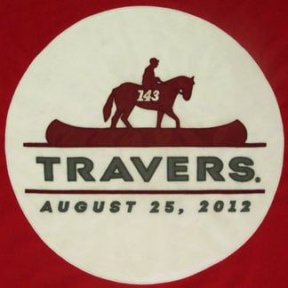 A close up of the appliqued logo for the Travers Race Winner fleece blanket.